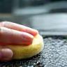 Technician washing a car with a soft sponge